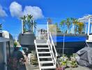 Stylish outdoor terrace with stairs, potted plants, and seating area