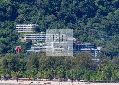 Coastal residential buildings surrounded by lush greenery