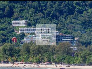 Coastal residential buildings surrounded by lush greenery