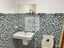 Modern bathroom with mosaic tiles and wall-mounted sink