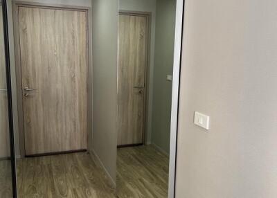 Hallway with wooden flooring and mirrored closet doors