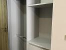 Spacious bedroom closet with open shelves and hanging rods