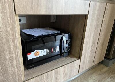 Built-in microwave in wooden kitchen cabinets