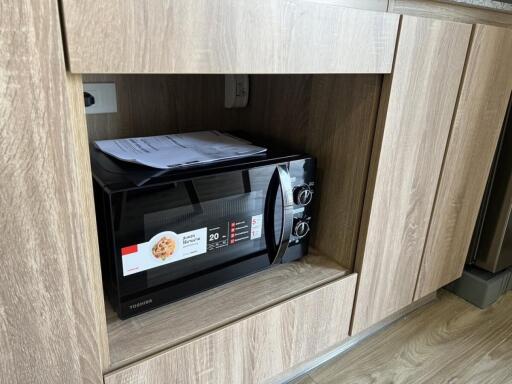 Built-in microwave in wooden kitchen cabinets