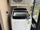 Compact laundry area with washing machine and air conditioning unit