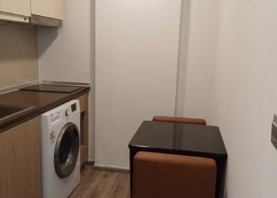 Cozy kitchen with table and washing machine