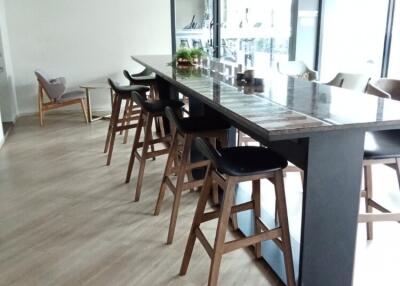 Modern dining area with high chairs and wooden accents