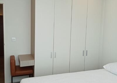 Modern bedroom with large wardrobe and study area