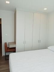 Modern bedroom with large wardrobe and study area