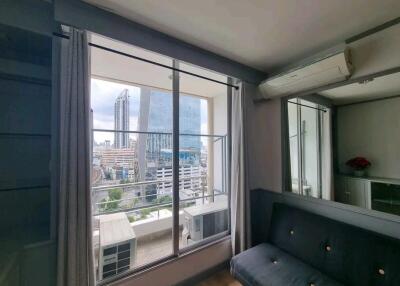 Living room with large window and city view