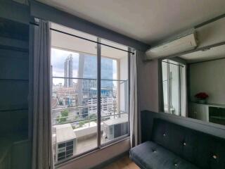 Living room with large window and city view