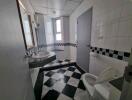 Modern bathroom with checkered floor tiles and large mirror