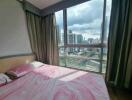 Bedroom with large window and city view