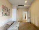 Bedroom with double bed, art on wall, and white wardrobe