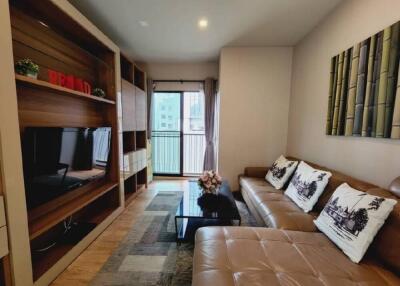 Modern living room with cozy brown couch and entertainment center