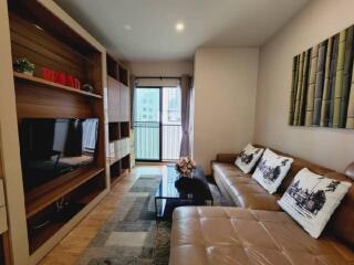 Modern living room with cozy brown couch and entertainment center