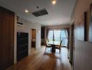 Modern dining room with wooden flooring and large windows