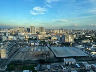 Aerial view of a cityscape with tall buildings and a factory