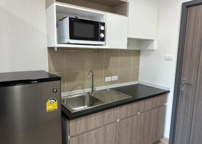 Modern kitchen with built-in microwave and refrigerator