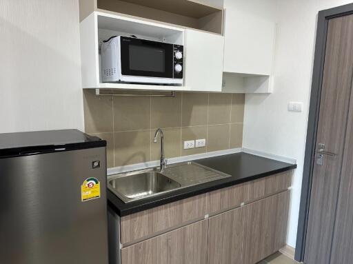 Modern kitchen with built-in microwave and refrigerator