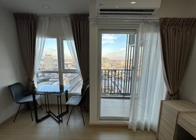 Bright living area with dining table and balcony view