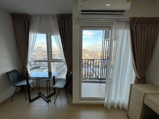 Bright living area with dining table and balcony view