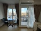 Bright living area with dining table and balcony view