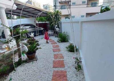 Garden walkway with pavers and decorative arches