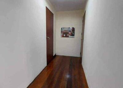 Long hallway with wooden floor and two doors