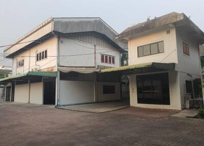 Exterior view of two connected buildings with garages