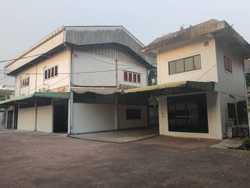 Exterior view of two connected buildings with garages