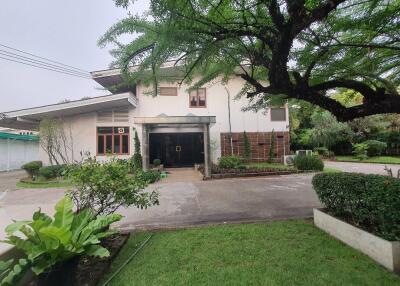 Front exterior view of the house with garden and driveway