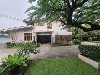 Front exterior view of the house with garden and driveway