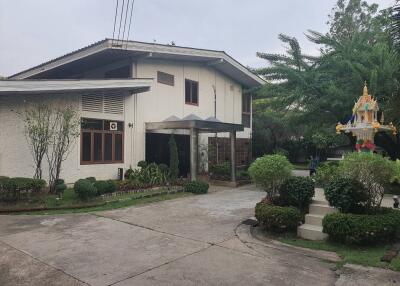 Front view of a house with driveway and garden