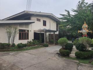 Front view of a house with driveway and garden