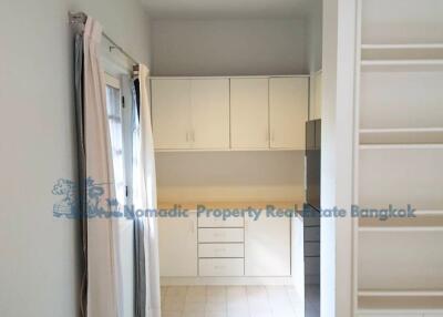 Small kitchen area with cabinets and sliding door