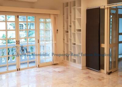 Bright living room with large windows and built-in shelves