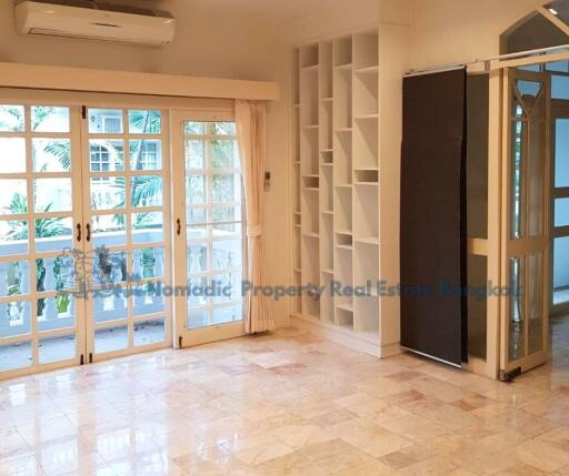 Bright living room with large windows and built-in shelves