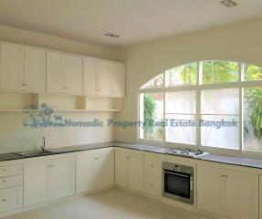 Spacious modern kitchen with large windows and built-in cabinets