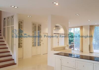 Spacious and bright main living area with modern kitchen and staircase