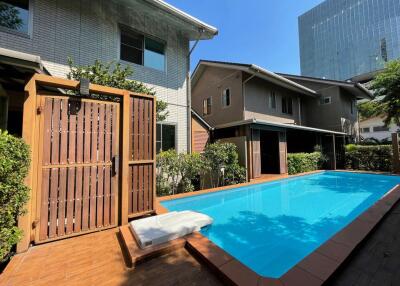 Outdoor area with swimming pool and nearby houses