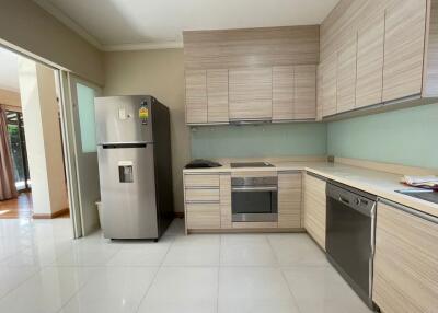 Modern kitchen with stainless steel appliances and wooden cabinets