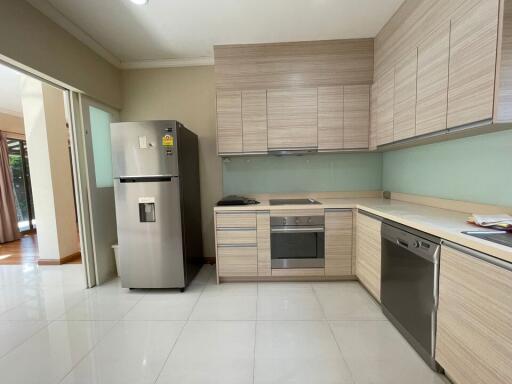 Modern kitchen with stainless steel appliances and wooden cabinets