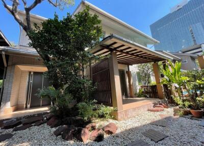 Exterior view of a two-story residential building with a landscaped front yard