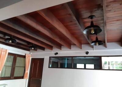 Living room with wooden ceiling and light fixtures