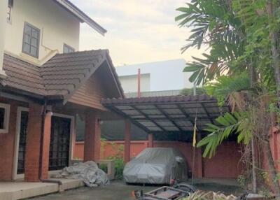 Outdoor view of a house with a driveway and carport