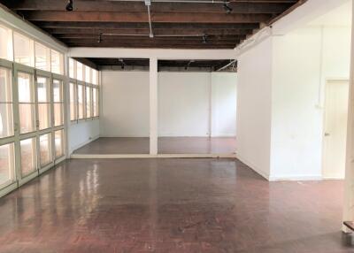 Spacious living area with wooden floor and exposed beams