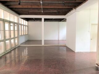 Spacious living area with wooden floor and exposed beams