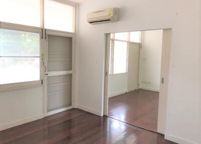 Bedroom with wooden flooring and air conditioning