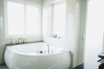 Bathroom with a bathtub and bright lighting